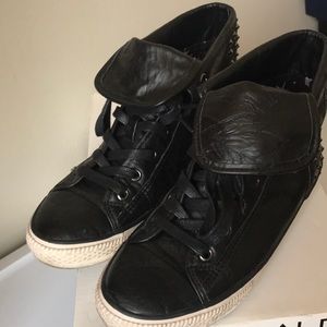 Women’s black studded sneakers.